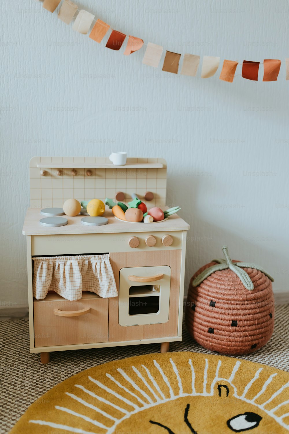 a wooden toy kitchen with a lion rug