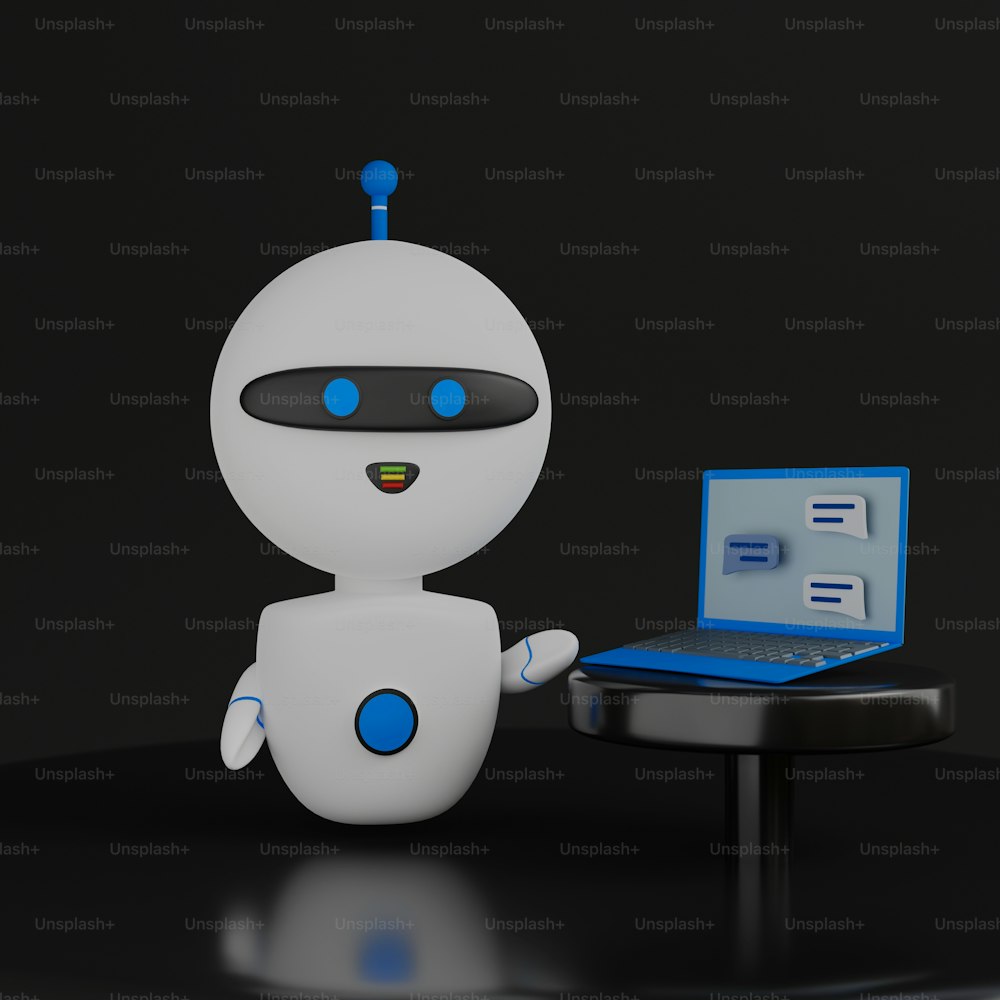 노트북 컴퓨터 앞에 앉아 있는 작은 로봇