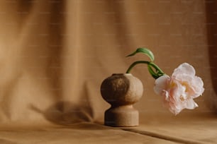 a small vase with a flower sticking out of it