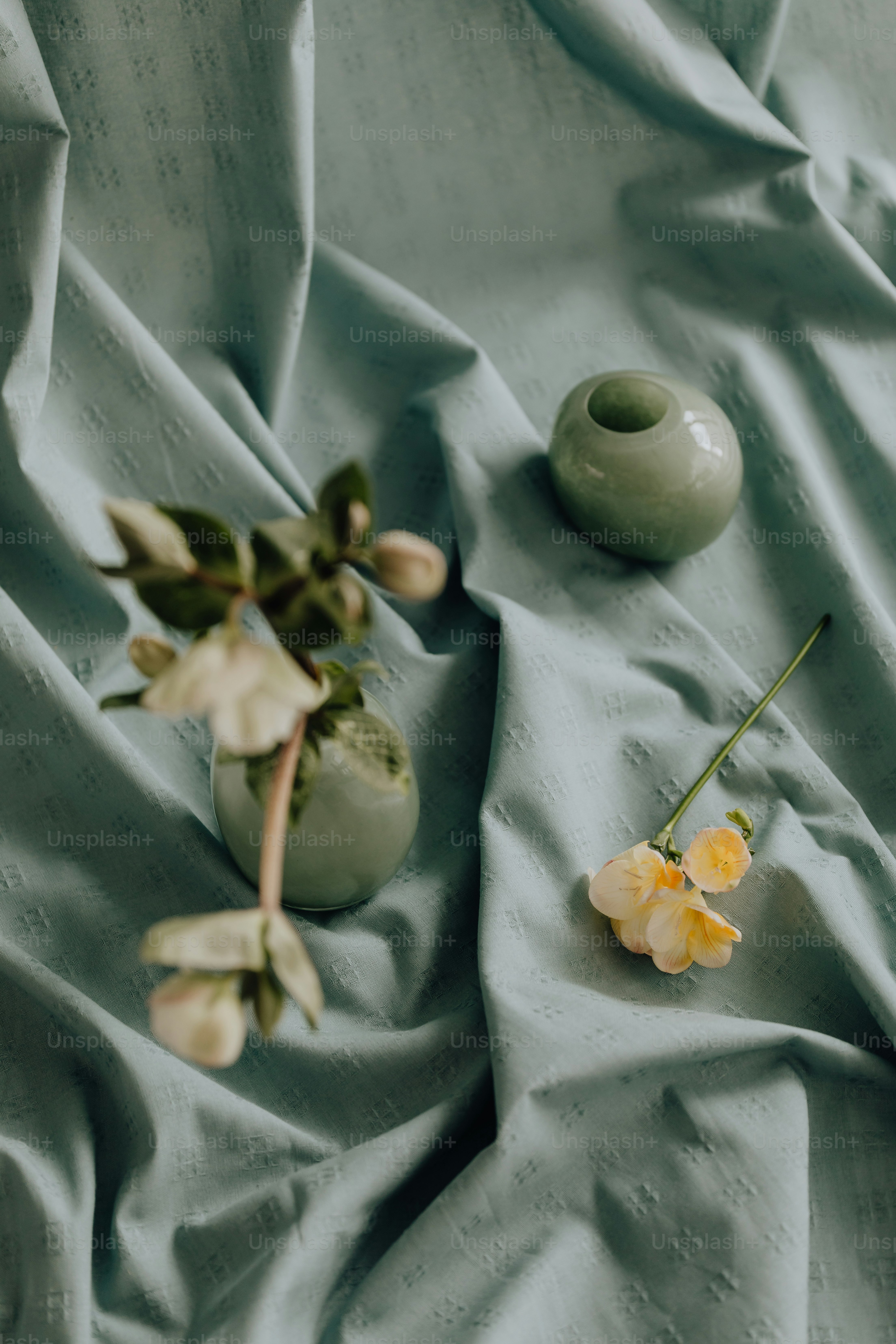 a couple of vases sitting on top of a bed