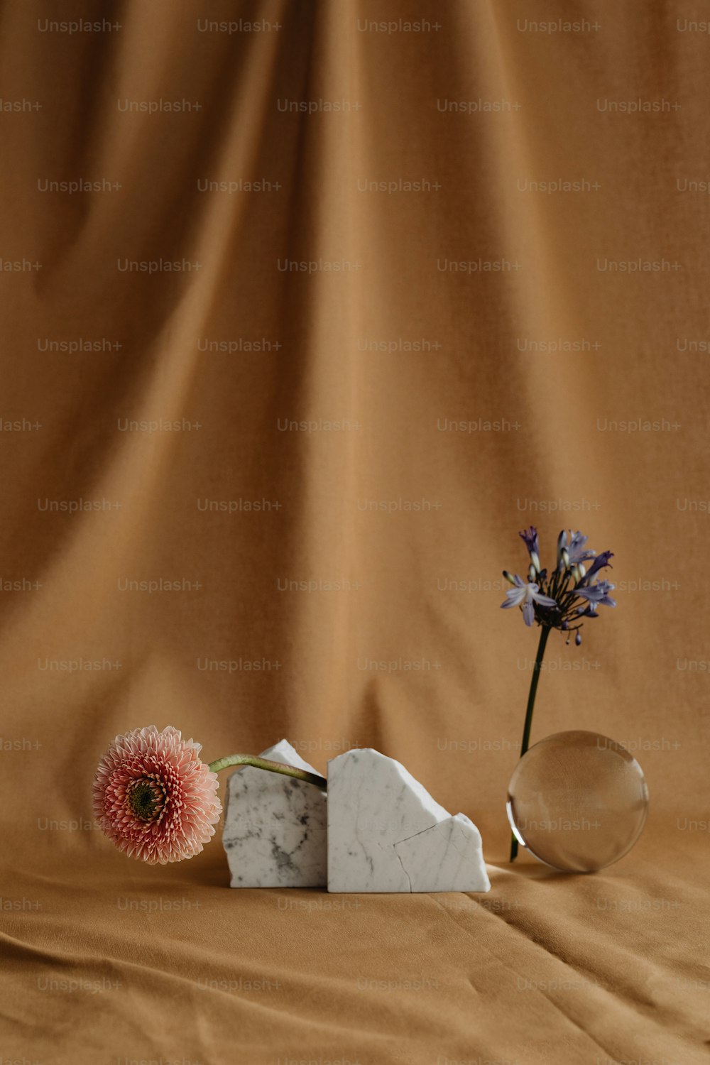 a vase with a flower and a marble block