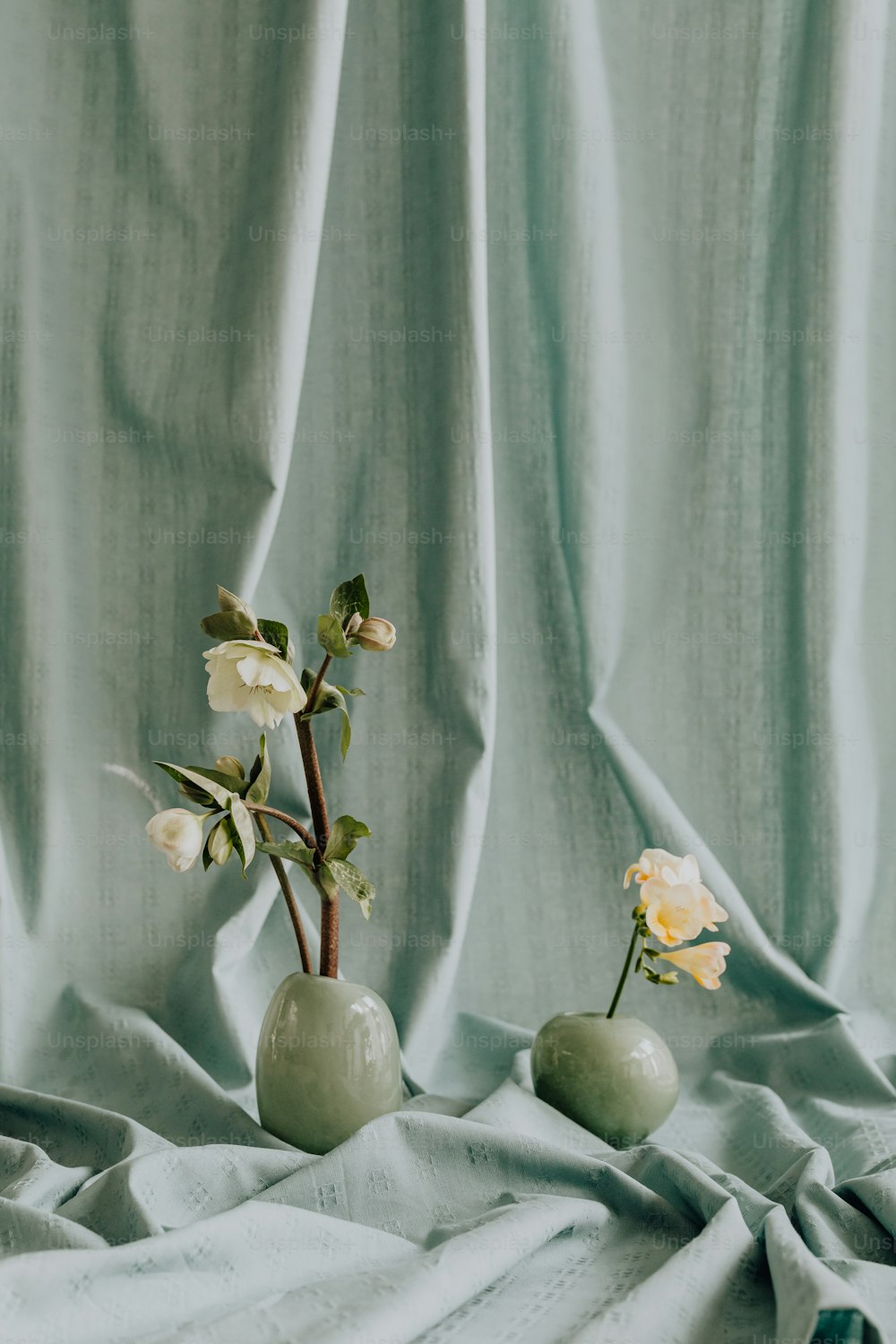 a couple of vases with flowers in them