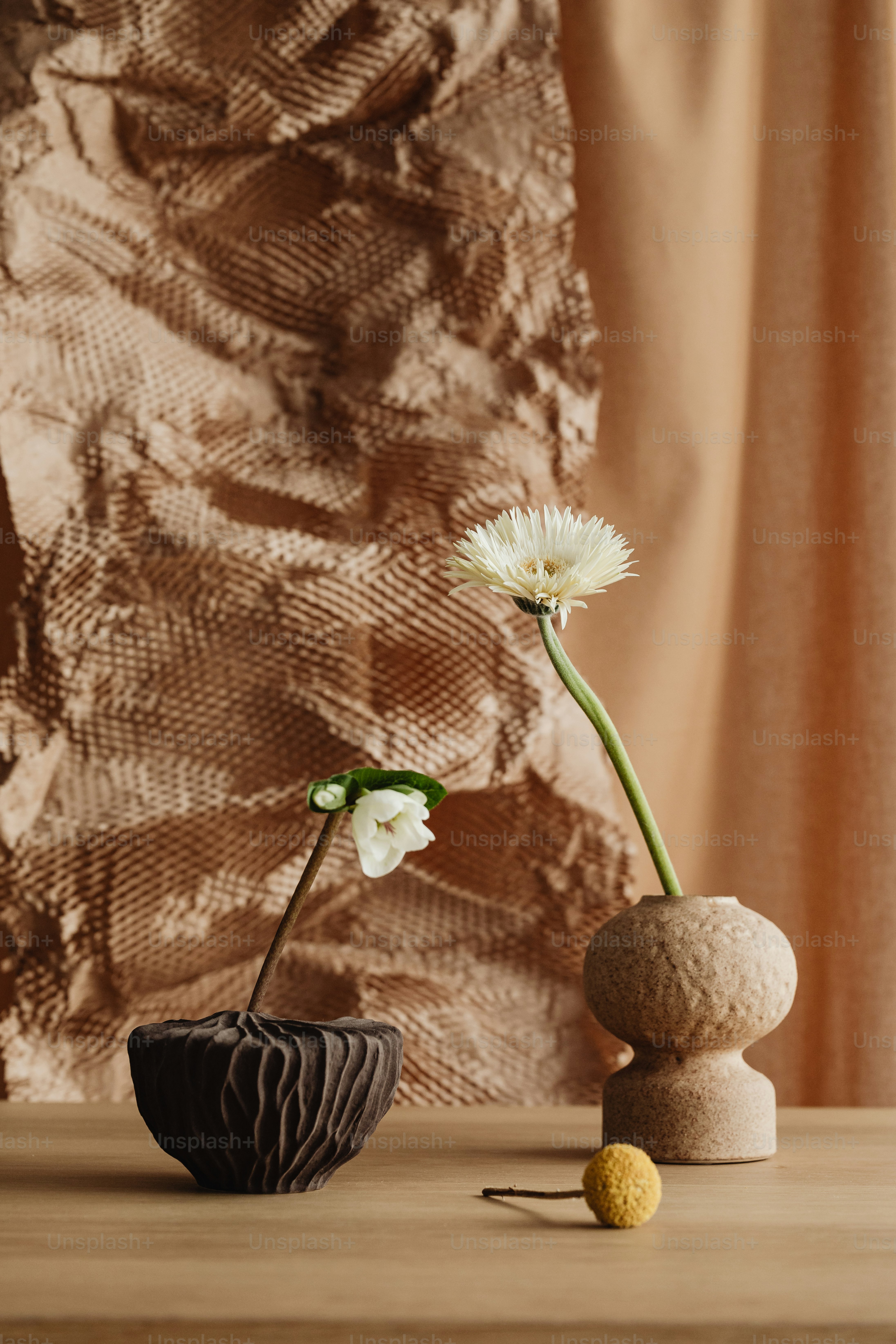 A vase with a flower in it sitting on a table photo – Floral ...
