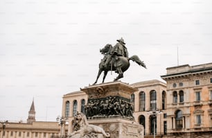 a statue of a man on a horse in front of a building