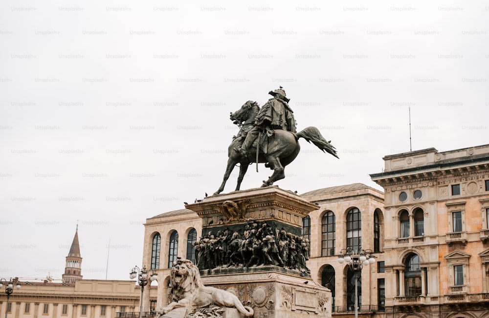 a statue of a man on a horse in front of a building