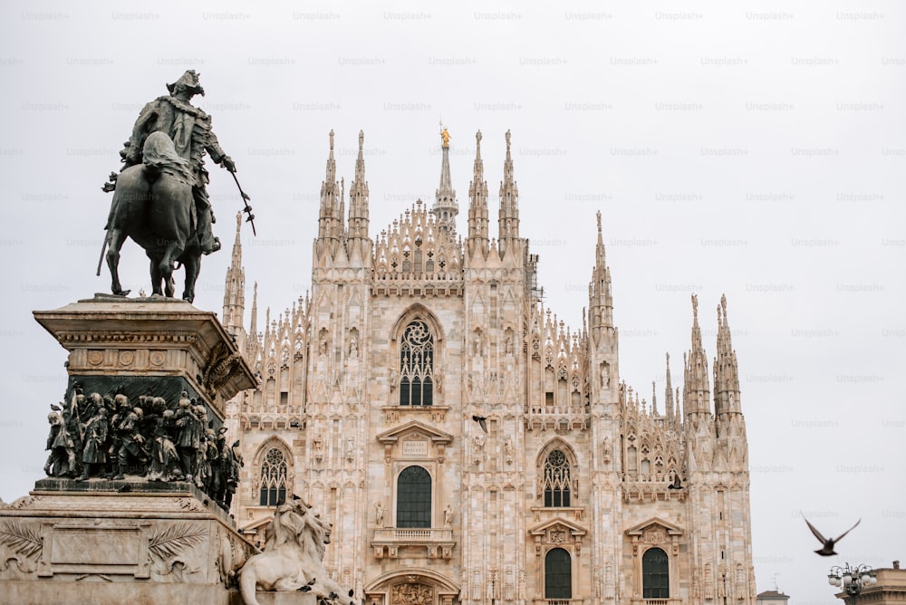 a statue of a man on a horse in front of a building