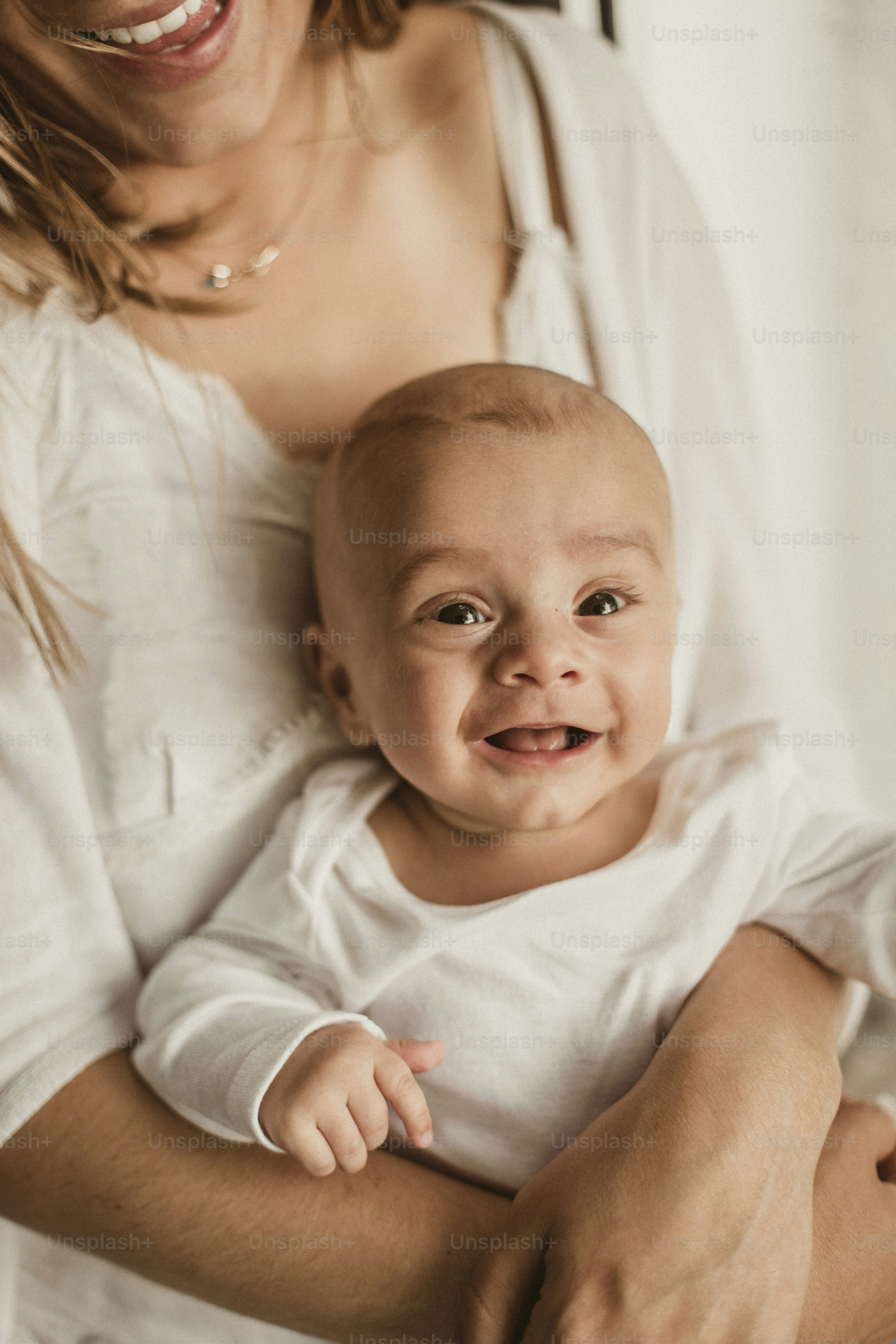 a woman holding a baby in her arms