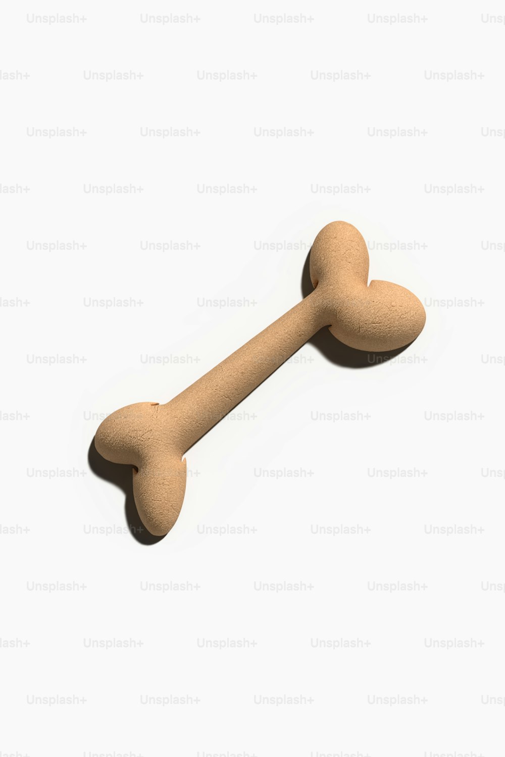 a wooden dog bone on a white background