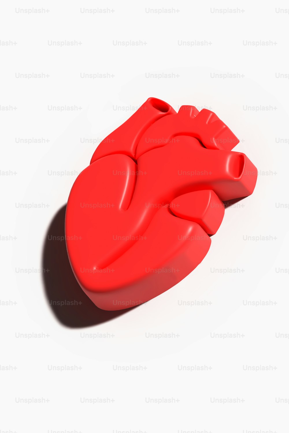 a red heart shaped object on a white background