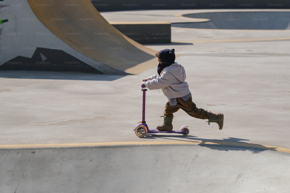 a person riding a scooter in a skate park