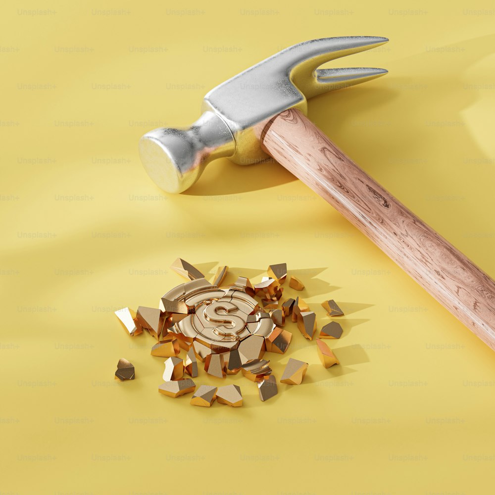 a hammer and a pile of rubble on a yellow background