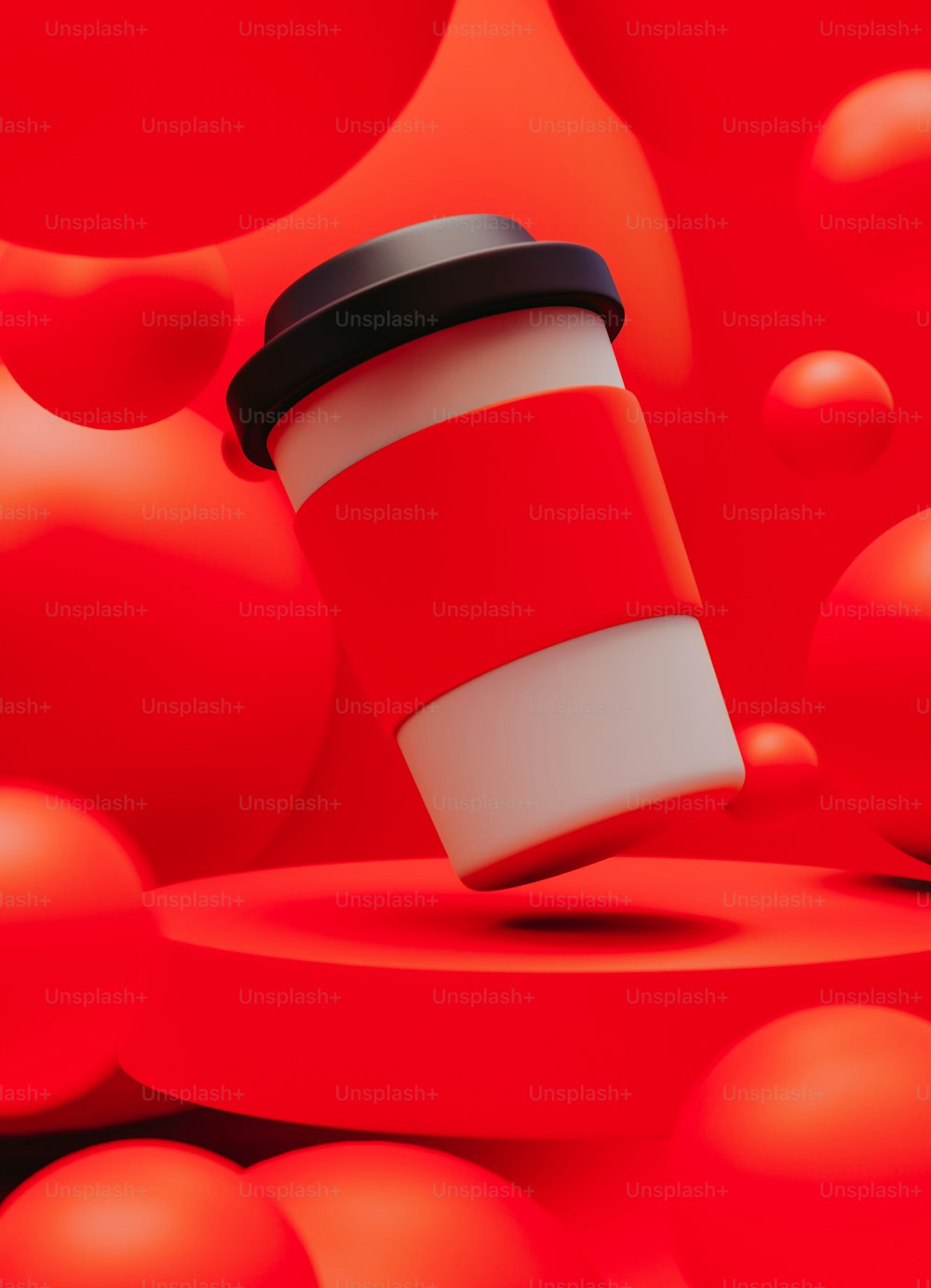 a coffee cup sitting on top of a red surface