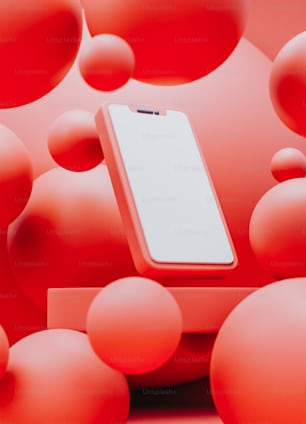 a cell phone sitting on top of a table surrounded by red balls