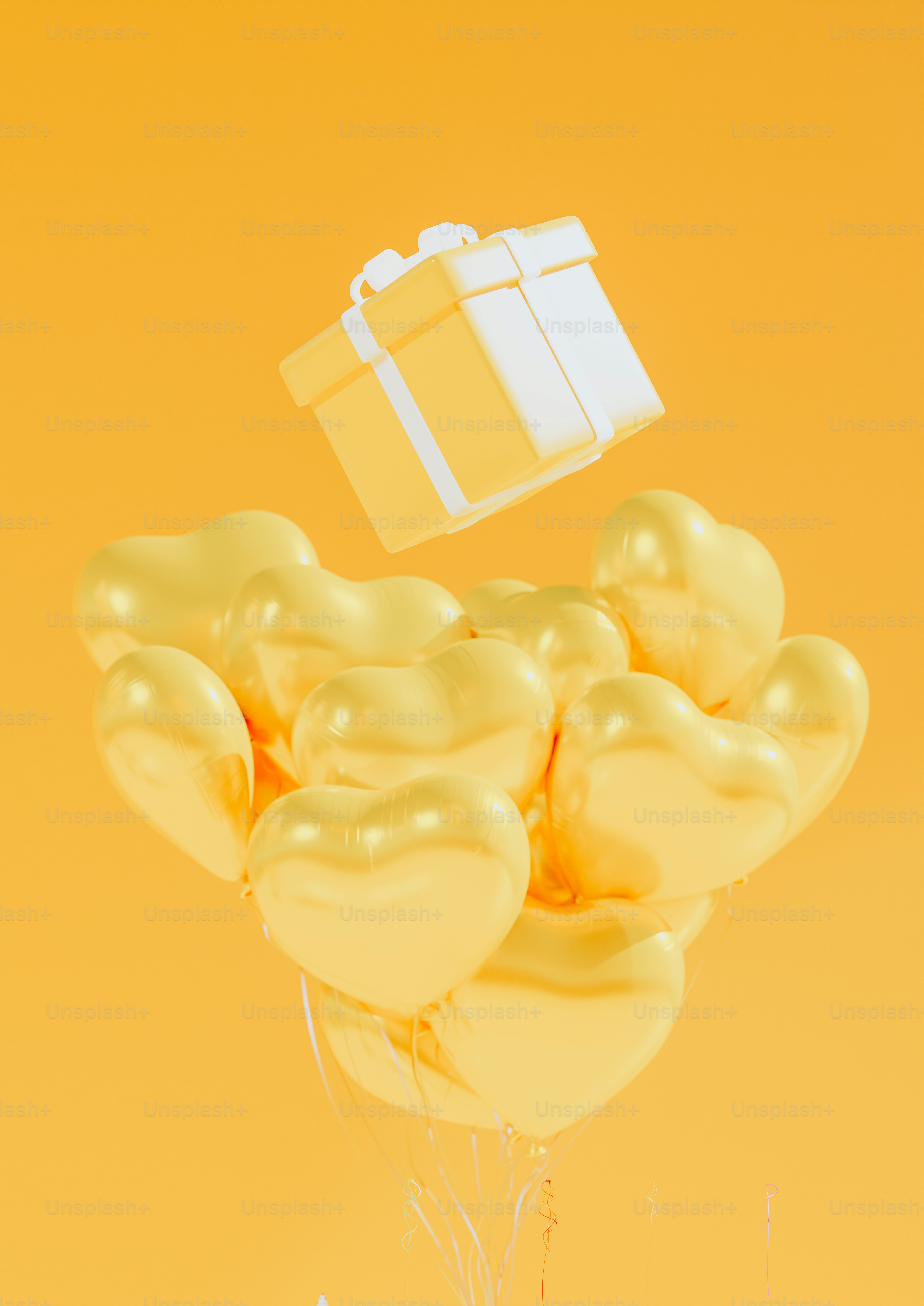 a bunch of balloons with a present on top of them