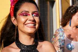 a woman with glitter on her face smiling