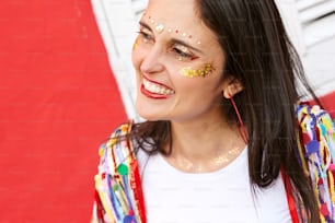 a woman with gold glitter on her face