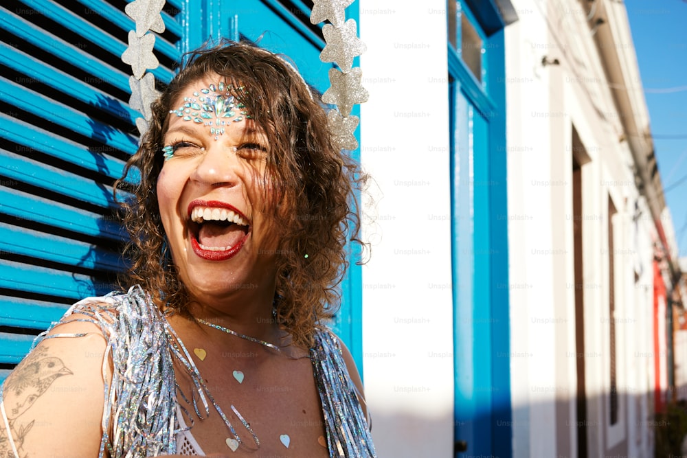 a woman wearing a silver dress and smiling