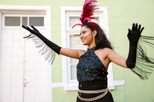 a woman wearing a black dress and a pink feathered hat