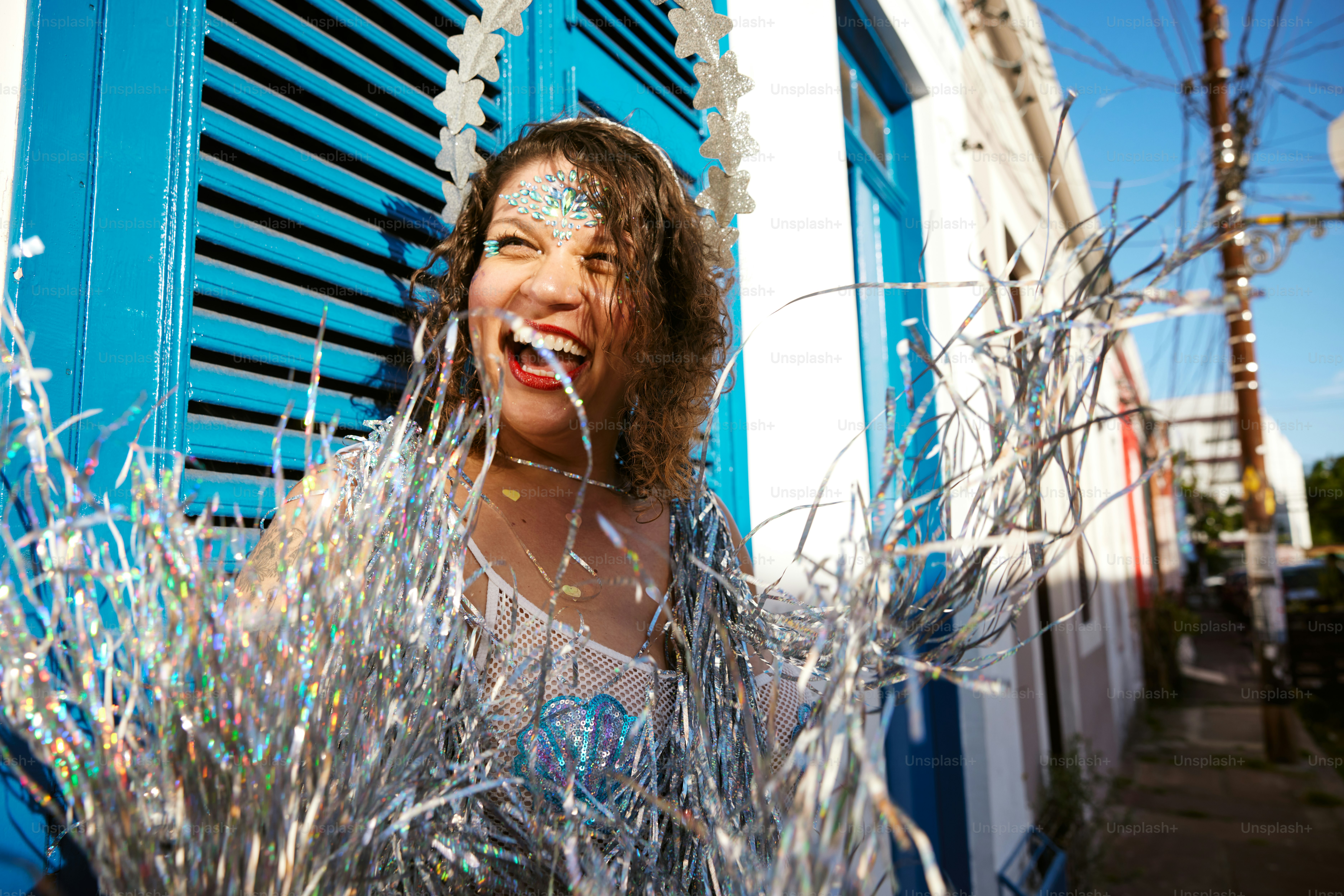 a woman standing in front of a blue window