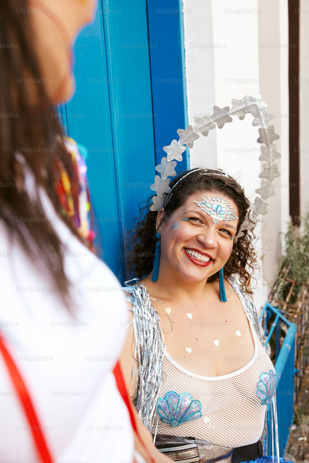 a woman in a white top and a blue door