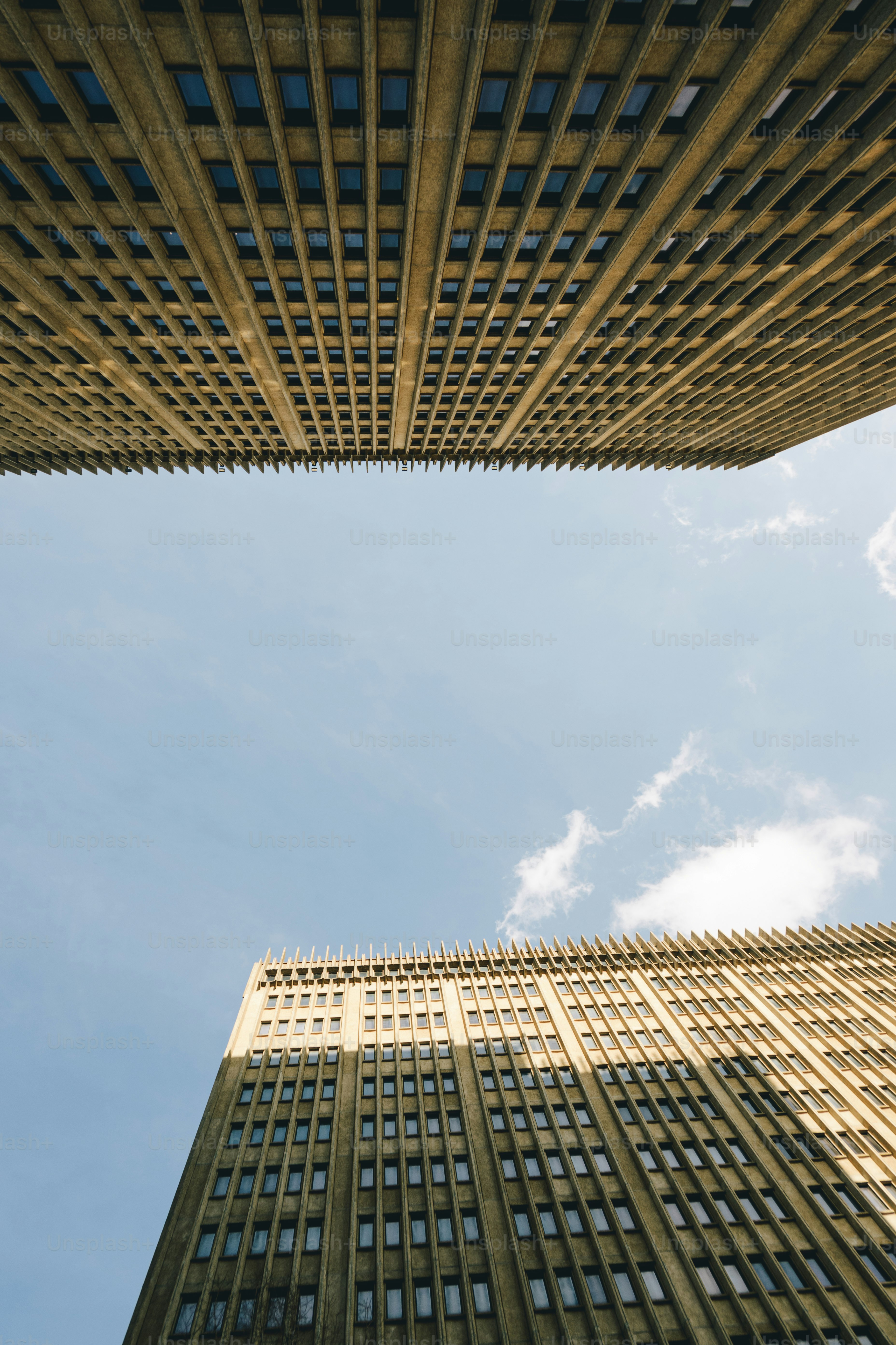 looking up at two tall buildings in a city