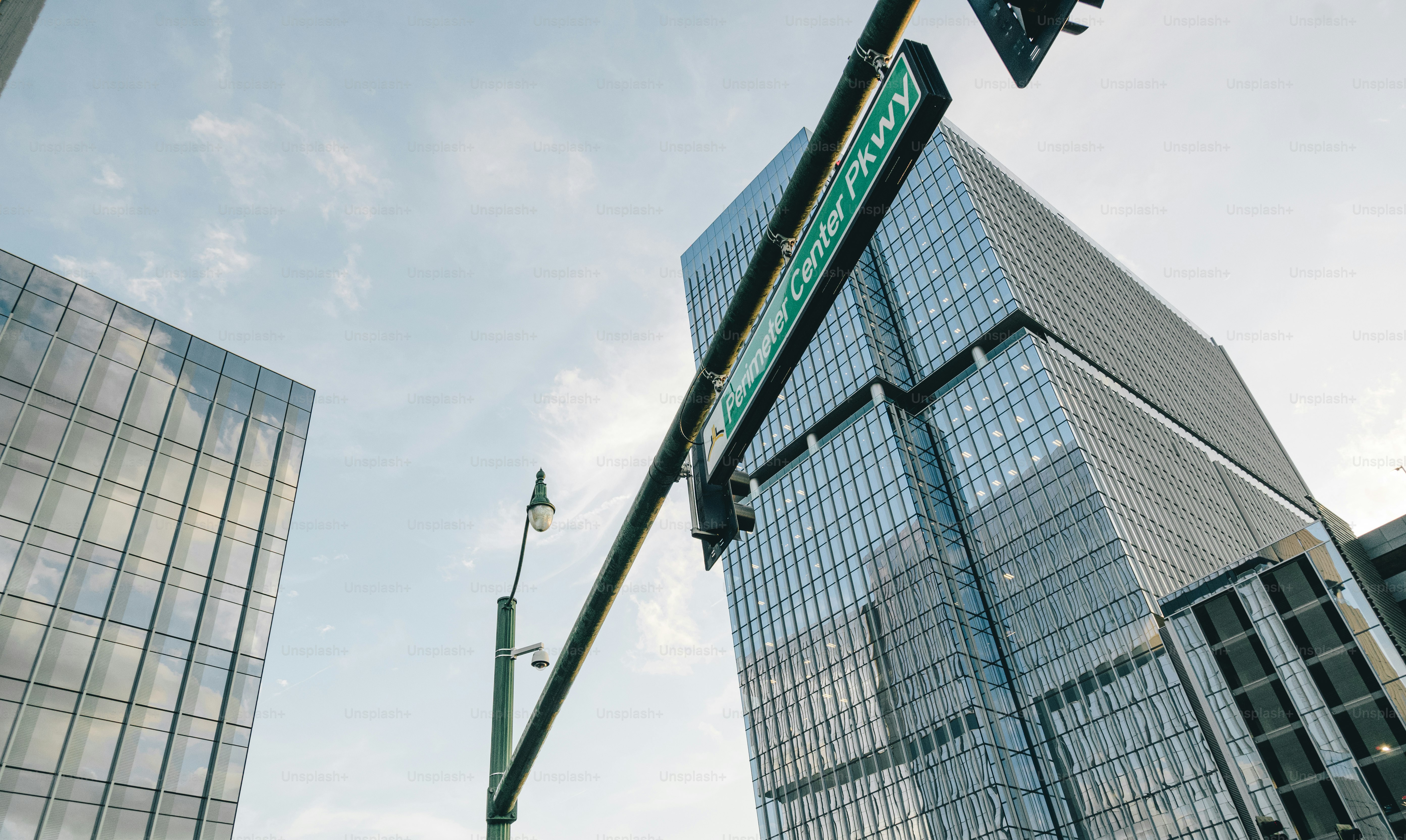a traffic light with a street sign hanging from it's side