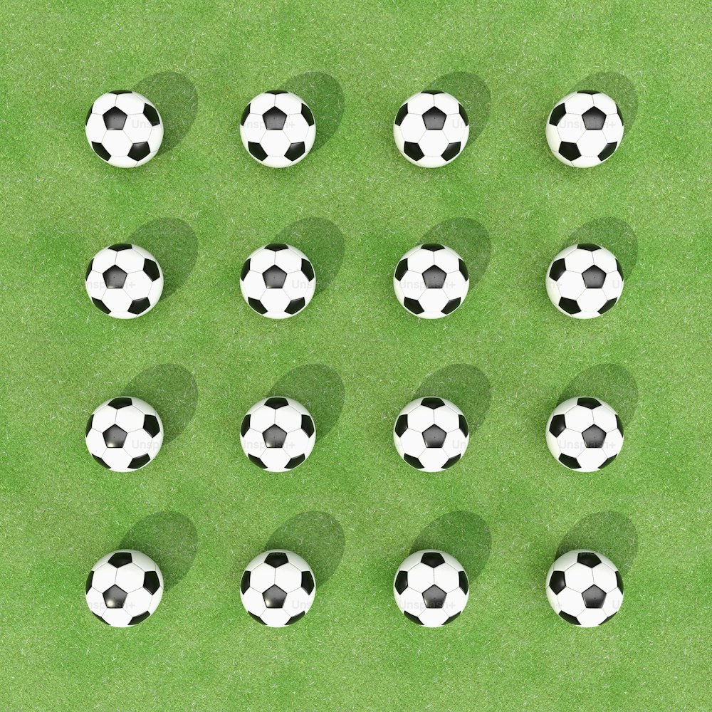 a group of soccer balls sitting on top of a green field