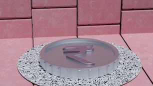 a round metal object with the letter r on it