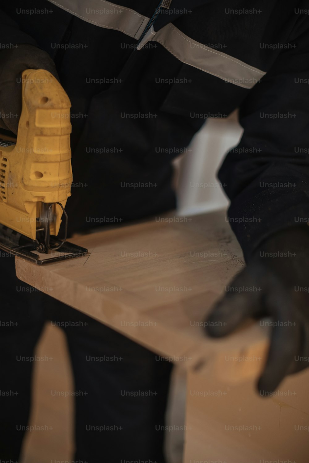 a man sanding a piece of wood with a sander
