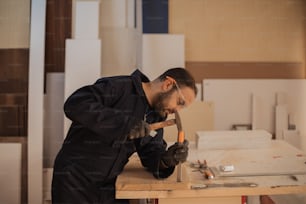 a man is working on a piece of wood