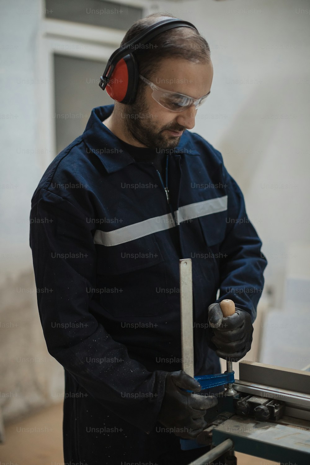 a man with headphones on working on a machine