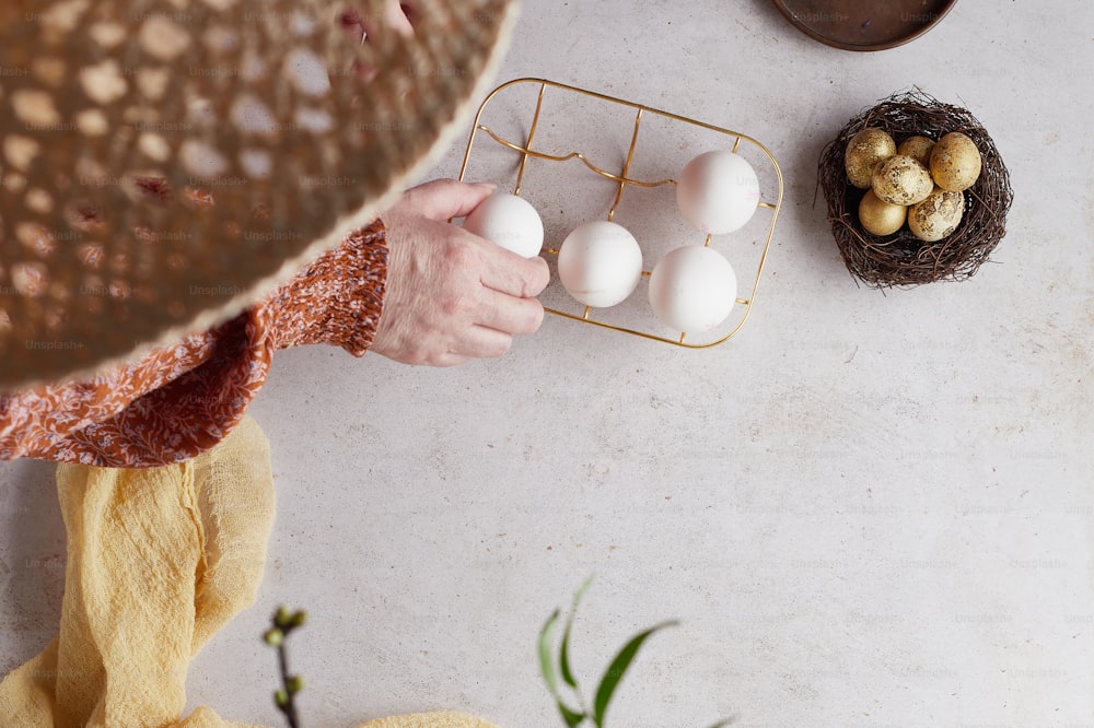 a person placing eggs in a basket on a table