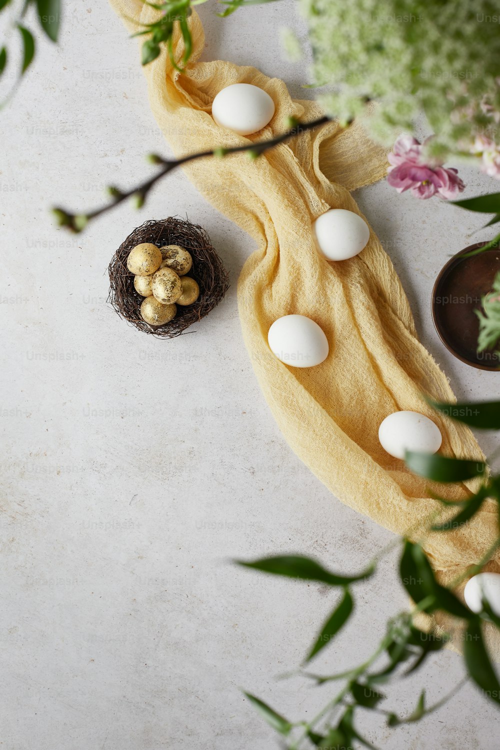 a table topped with a yellow towel covered in eggs