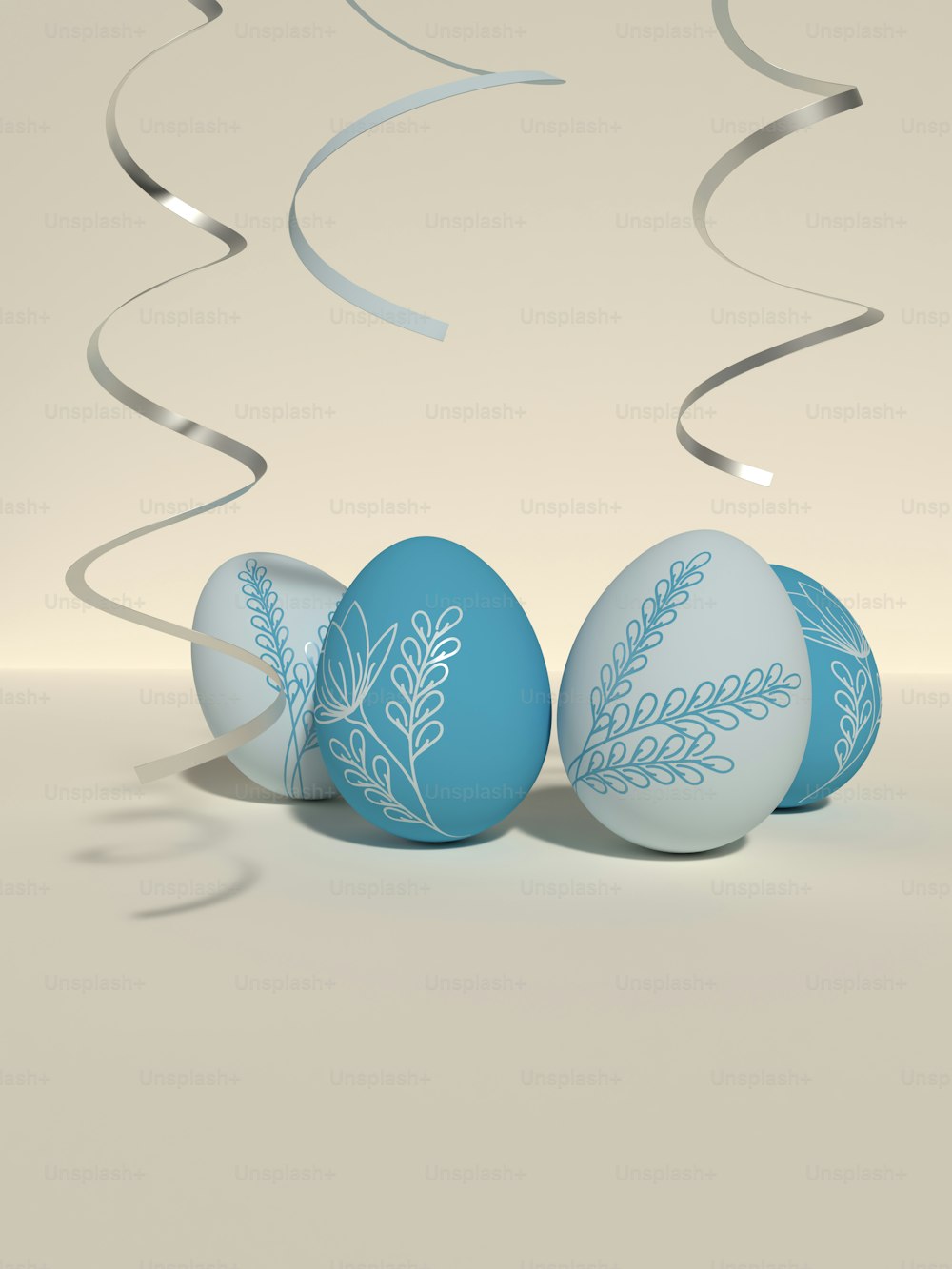 three blue and white decorated eggs on a table