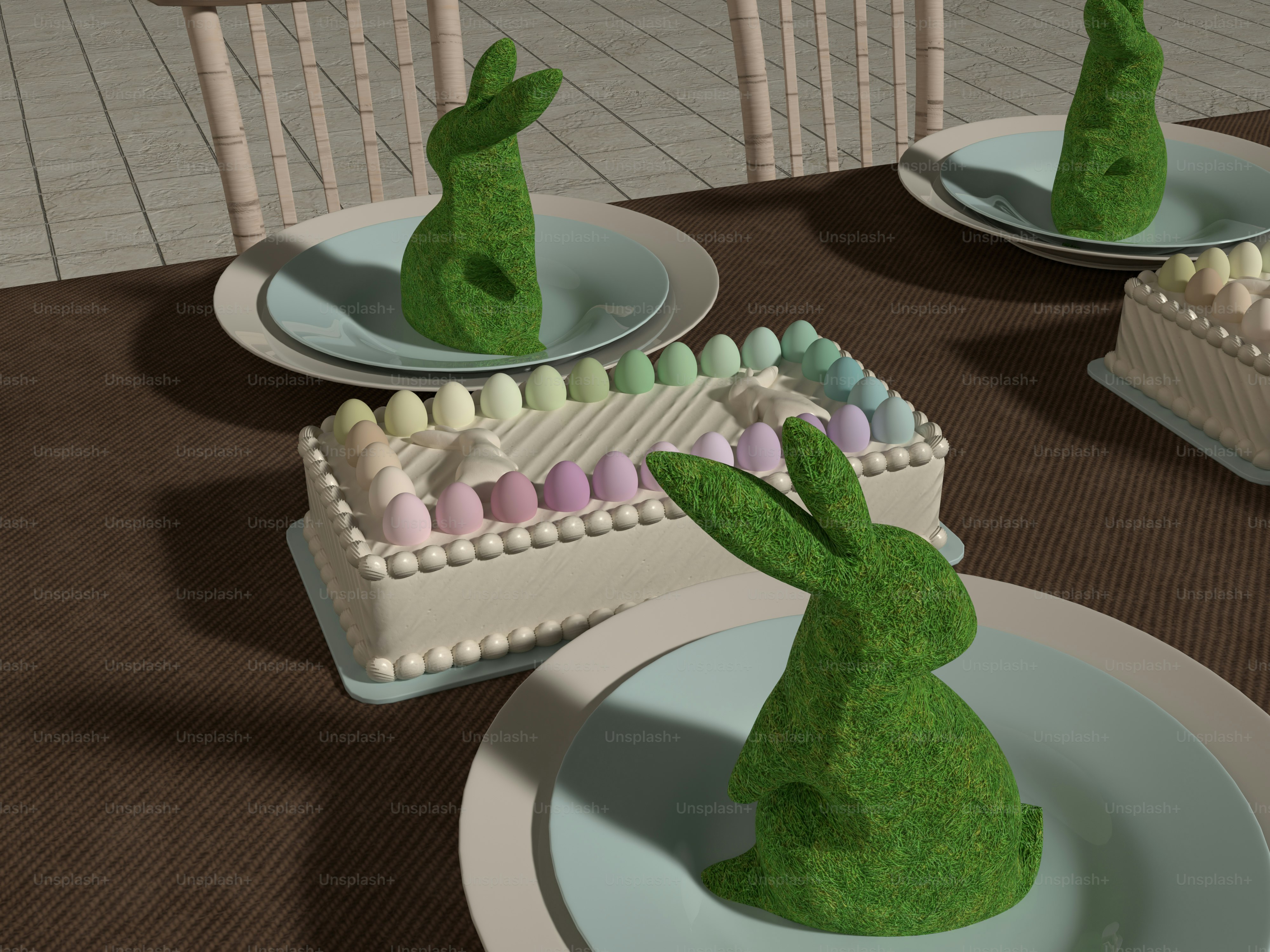 a table topped with plates filled with cakes and bunnies