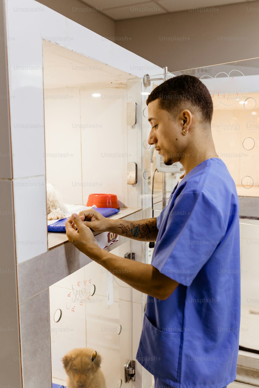 a man in scrubs is holding something in his hand