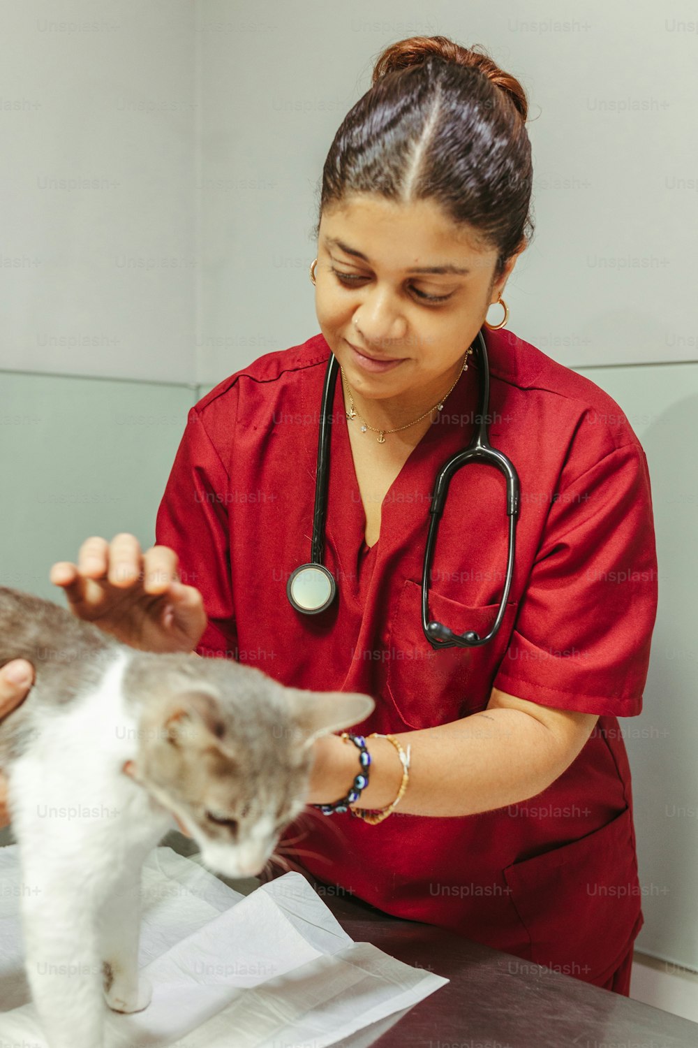 a woman in a red shirt is petting a cat