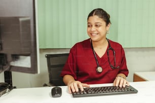 a woman sitting at a desk with a keyboard and mouse