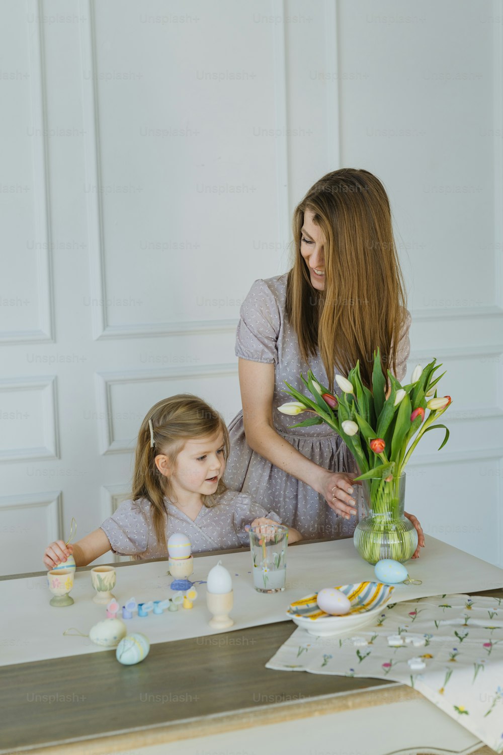 a woman and a little girl sitting at a table