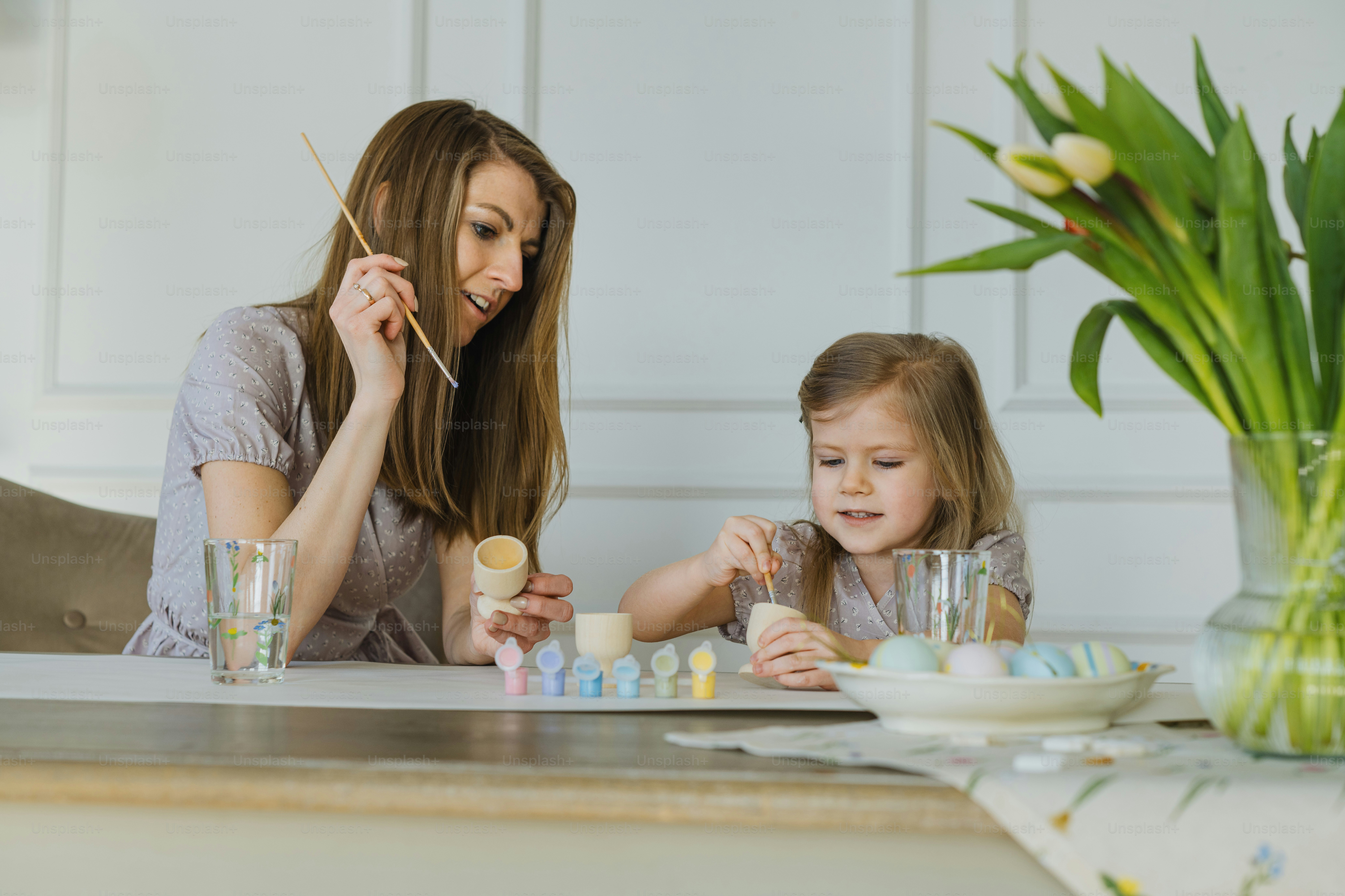 a woman and a little girl sitting at a table