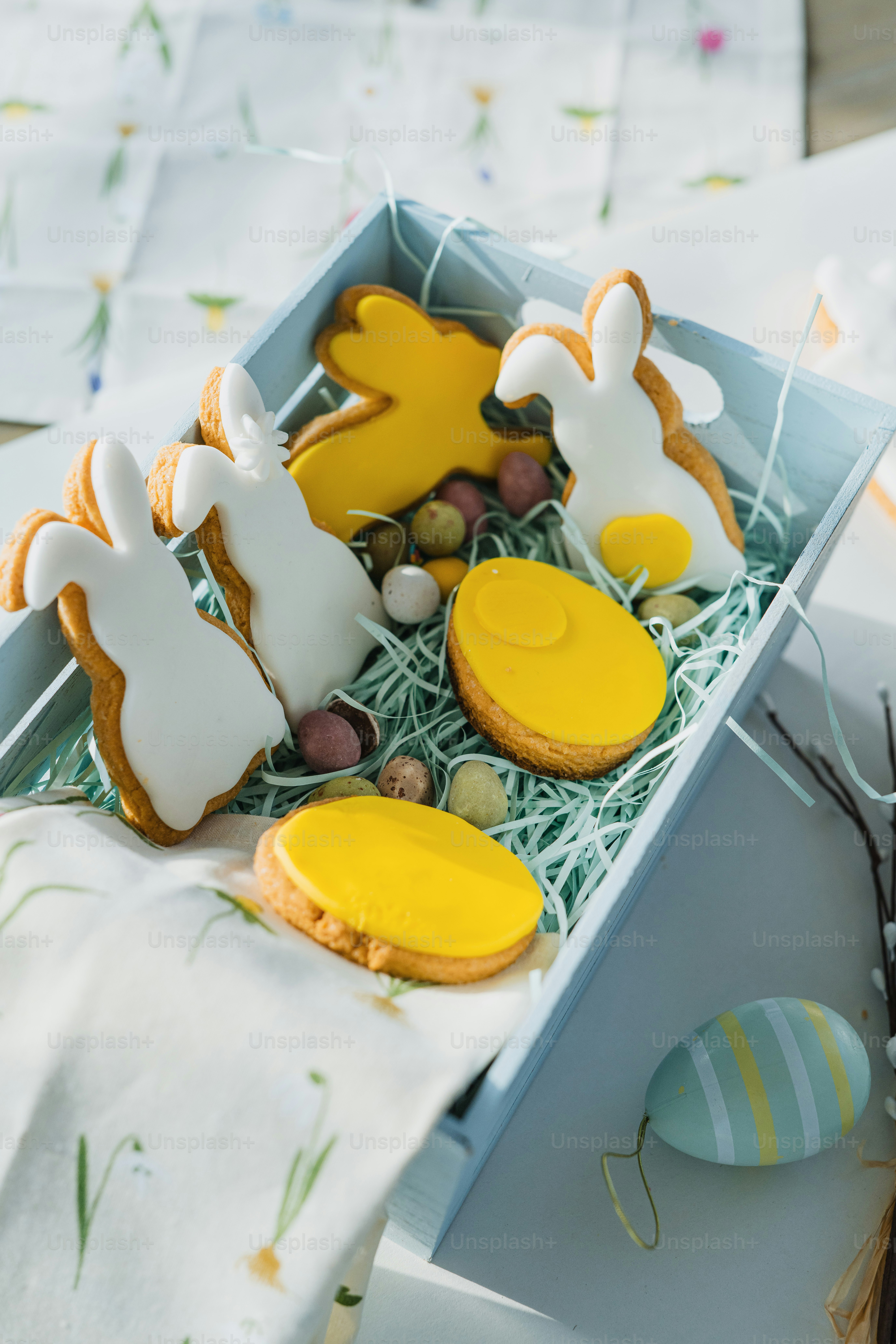 a box filled with decorated cookies on top of a table