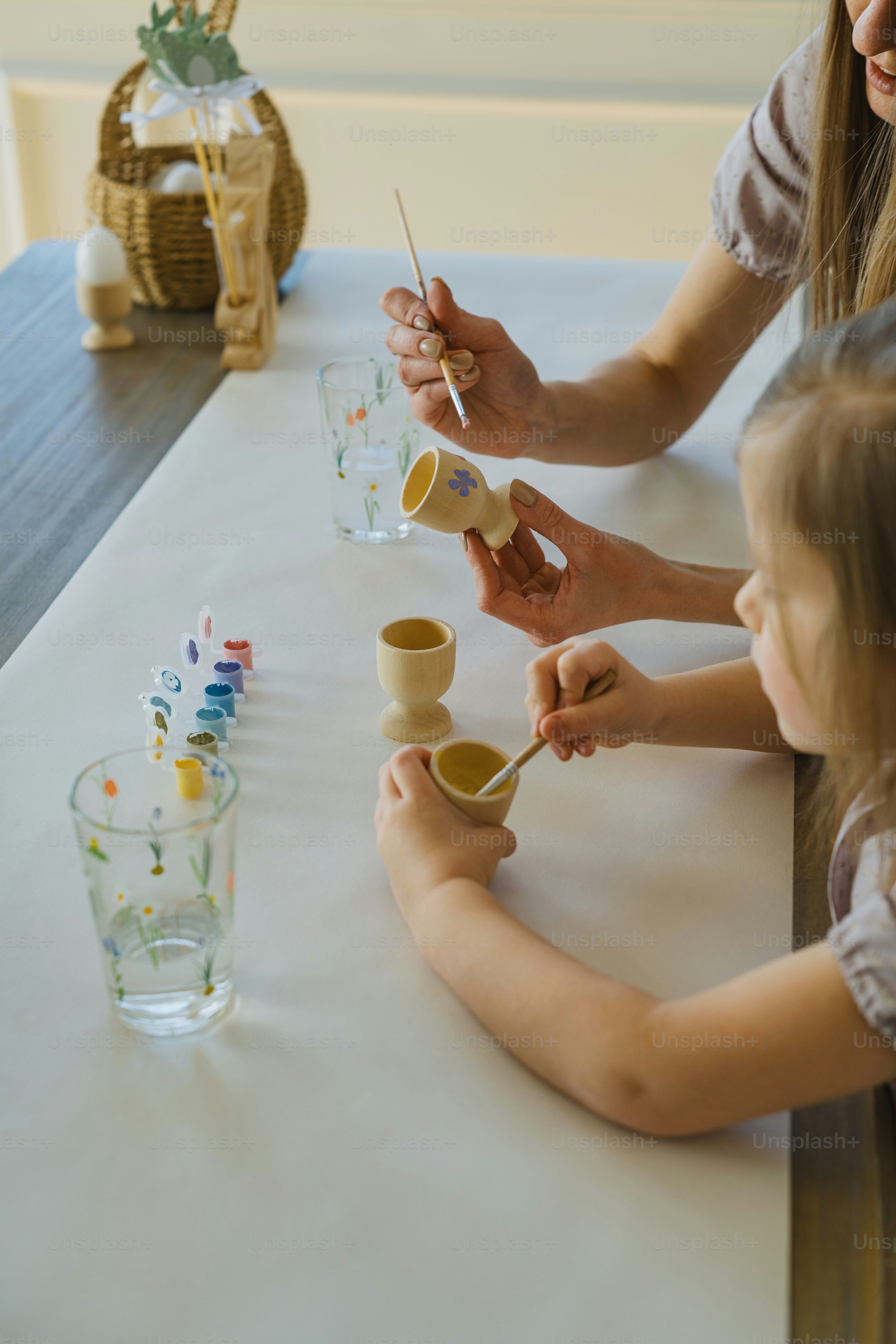 a woman and a little girl sitting at a table