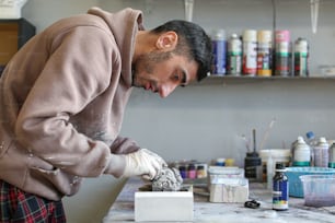 a man working on a piece of art