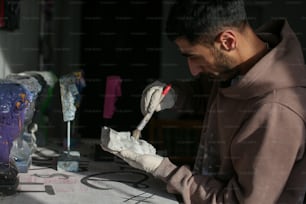 a man in a brown hoodie and white gloves