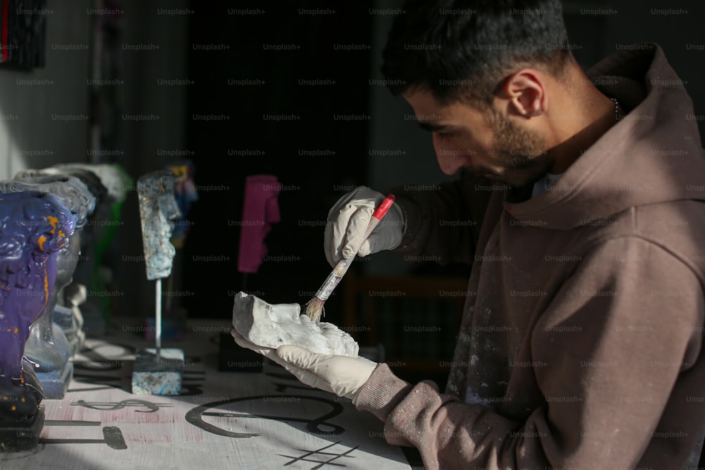 a man in a brown hoodie and white gloves