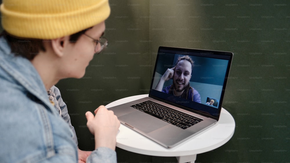 uma pessoa com um laptop em uma mesa