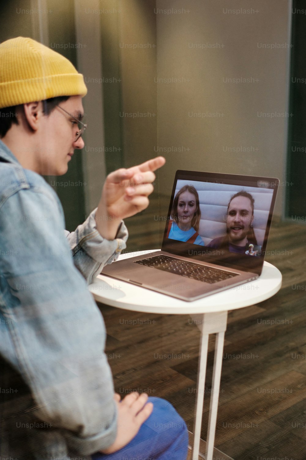 a man sitting in front of a laptop computer