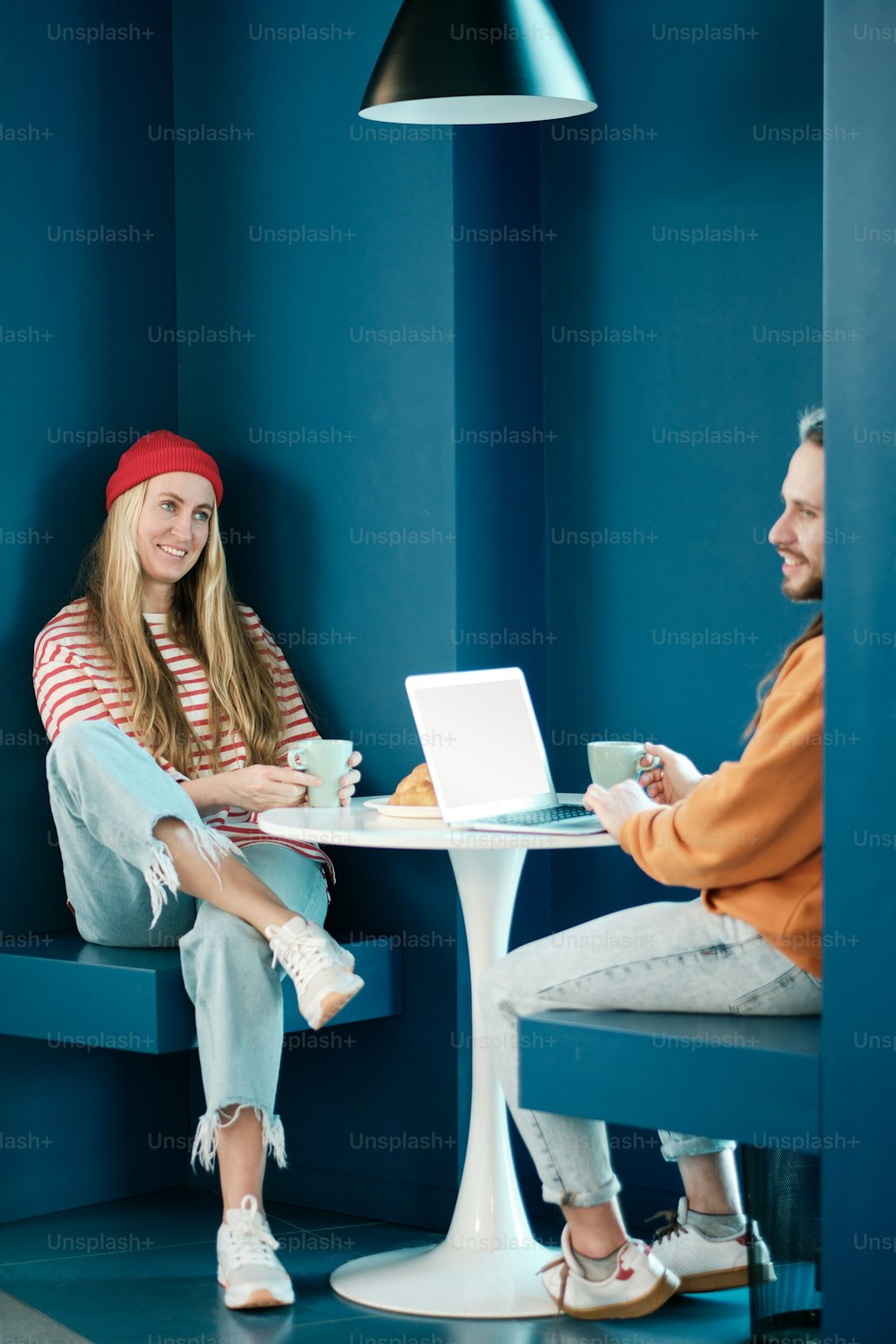 a woman sitting at a table with a laptop