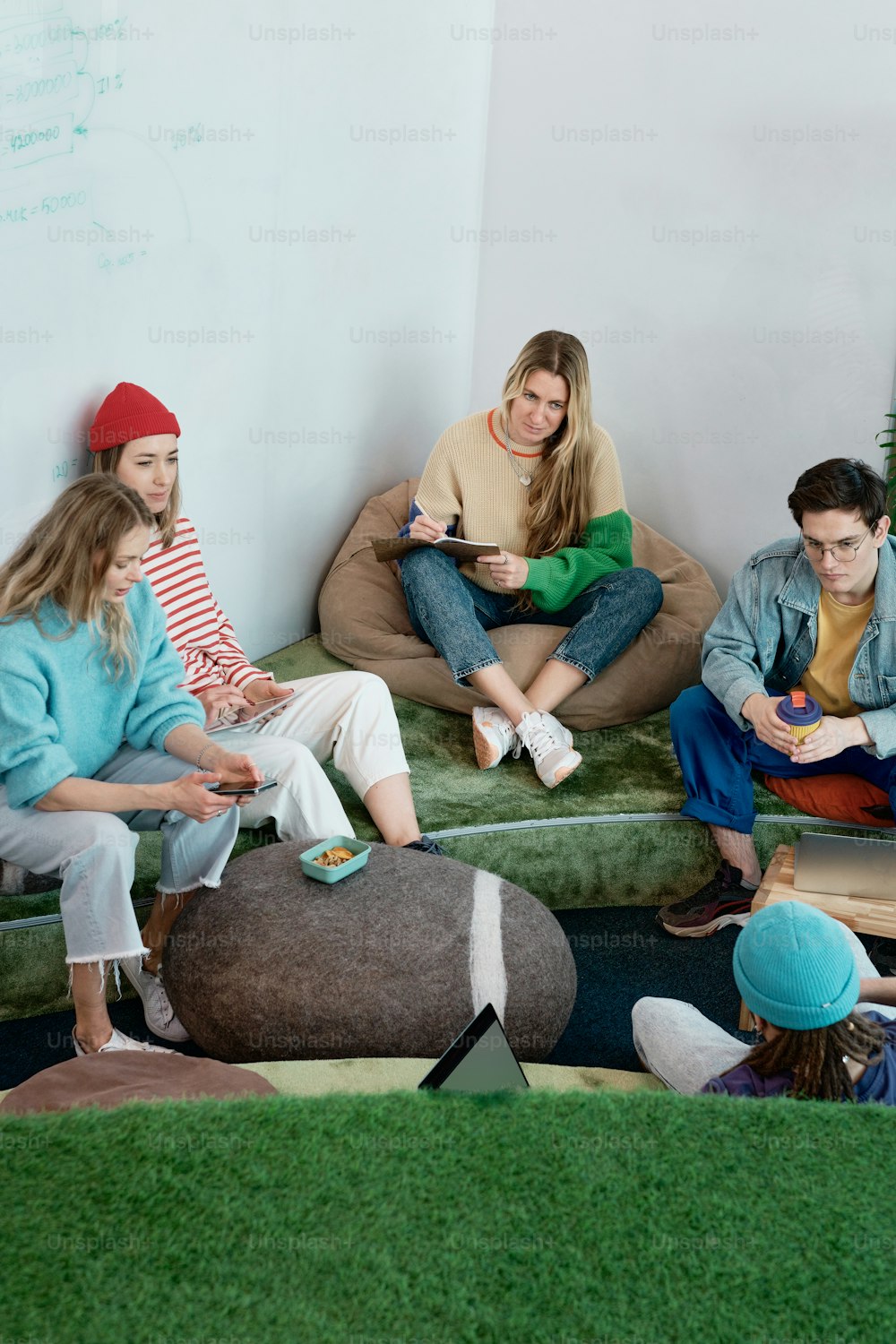 a group of people sitting on bean bags in a room
