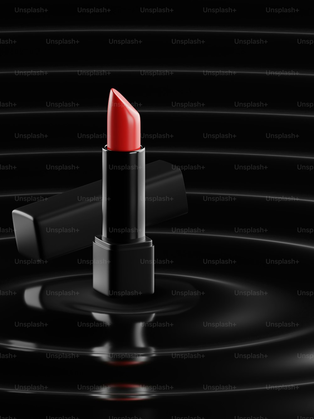 검은 표면 위에 놓인 빨간 립스틱